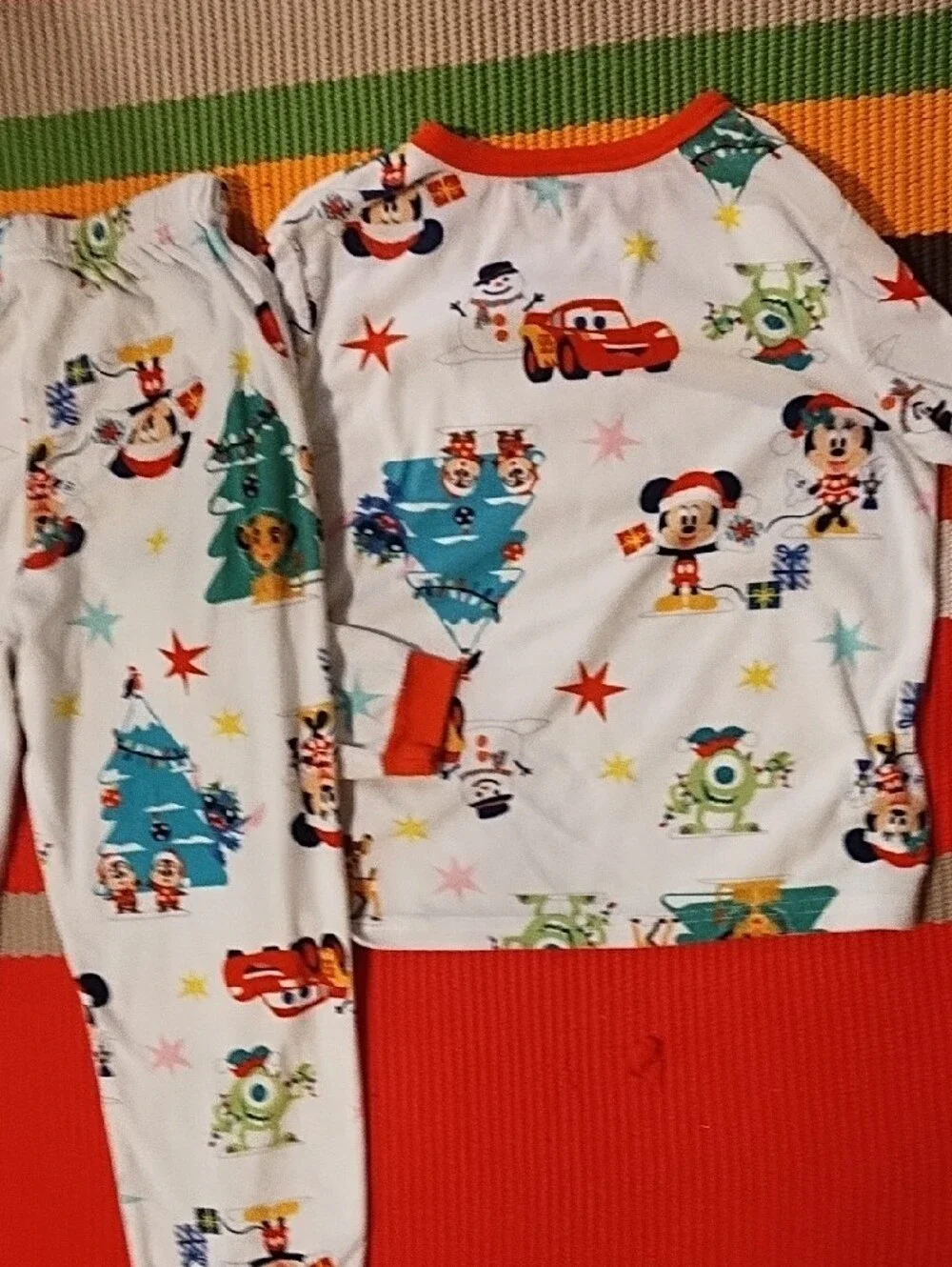 Disney Kids Holiday Pajama Set - White with Red Accents and Multicolor Prints.